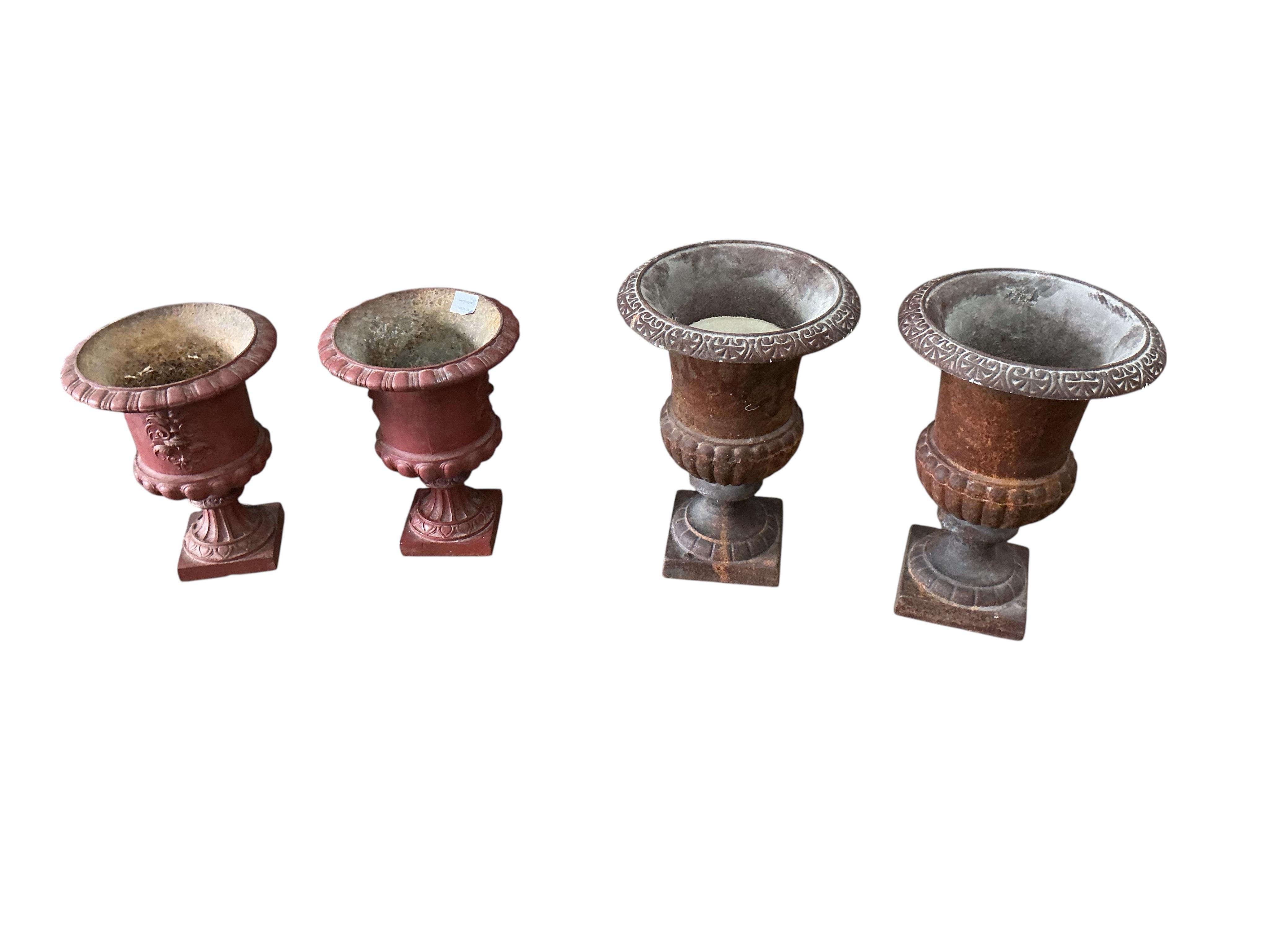 Two pairs of Victorian style cast iron campana urns, larger diameter 30cm, height 41cm, Provenance: The late Kenneth Turner (1936-2025), celebrity florist, designer and perfume retailer, he received the Royal Warrant fro